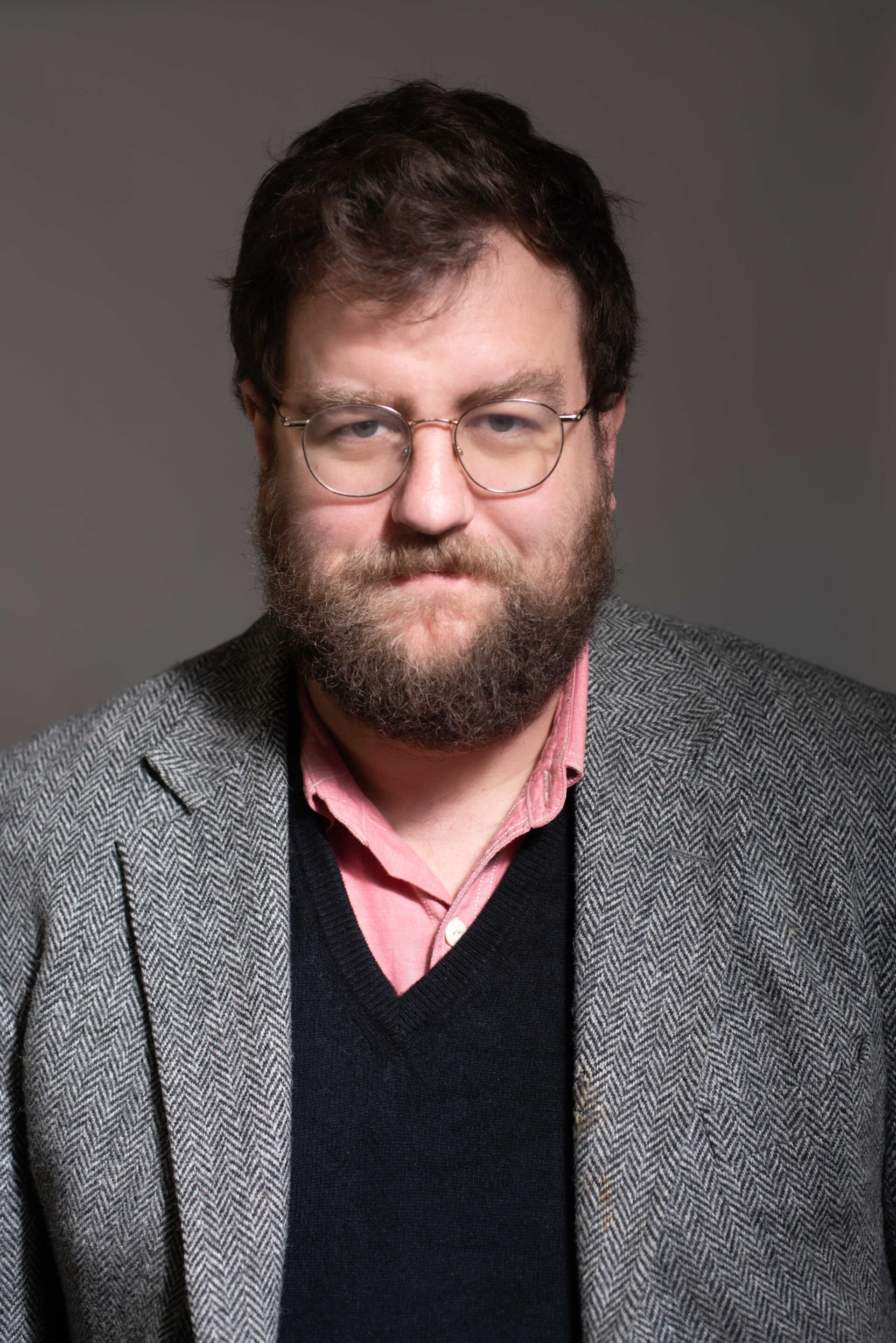 A photo of Nicholas Pullen wearing a pink shirt and grey blazer